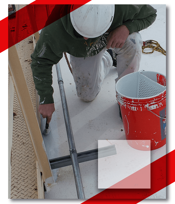 A man painting with red bucket