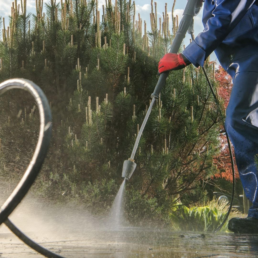 photo of someone power washing driveway