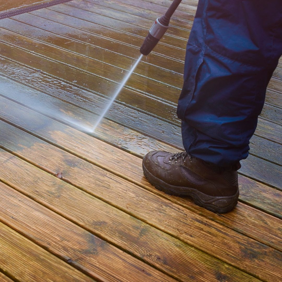 photo of someone power washing deck