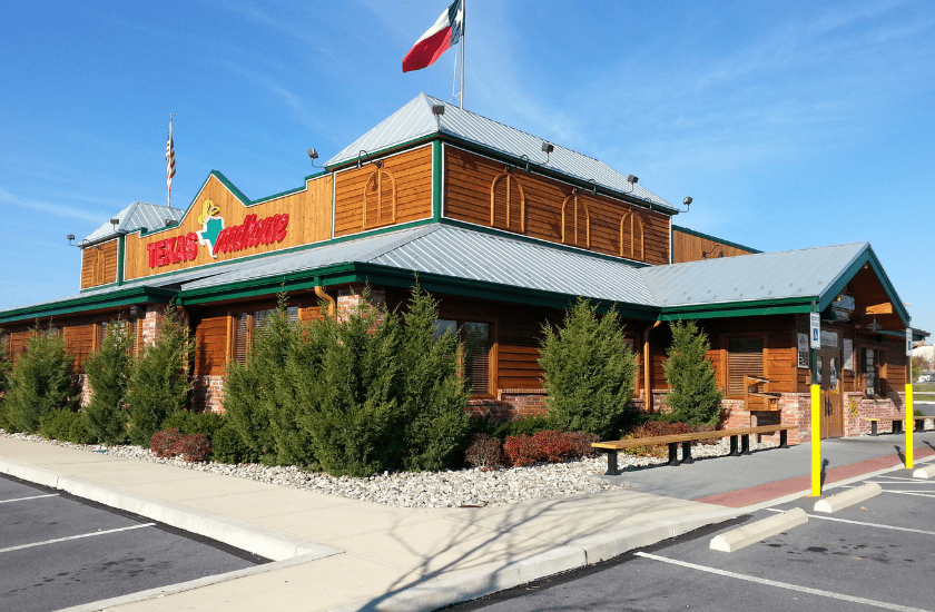Texas roadhouse commercial restaurant freshly stain wood siding with semi transparent stain and freshly painted green trim