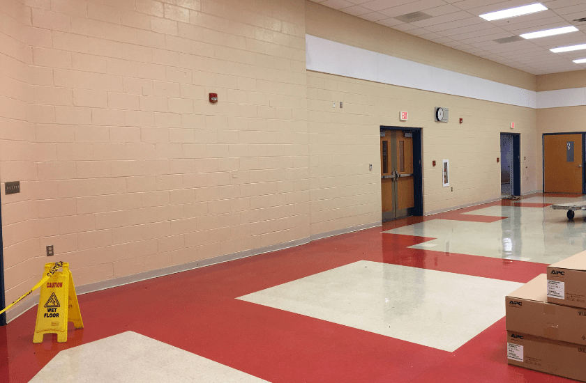 light tan block walls freshly painted in a middle school cafeteria