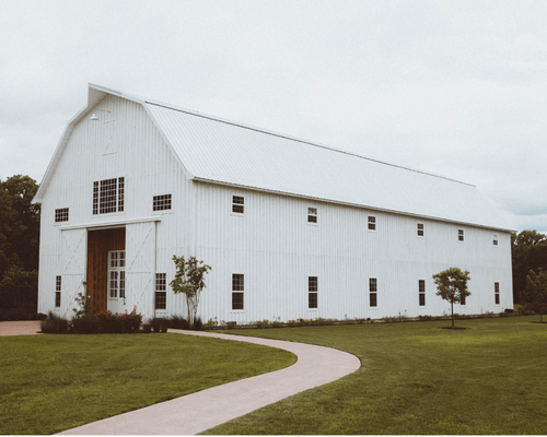 large wood barn painted white
