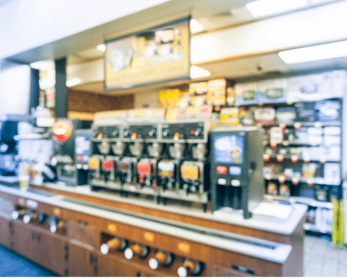 interior gas station painting The interior of a convenience store. The image is out of focus but one can make out a coffee station with several pots brewing.
