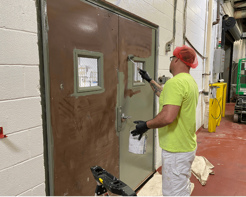 metal door painting Metal Door being painted by a professional painter in a food manufacturing facility