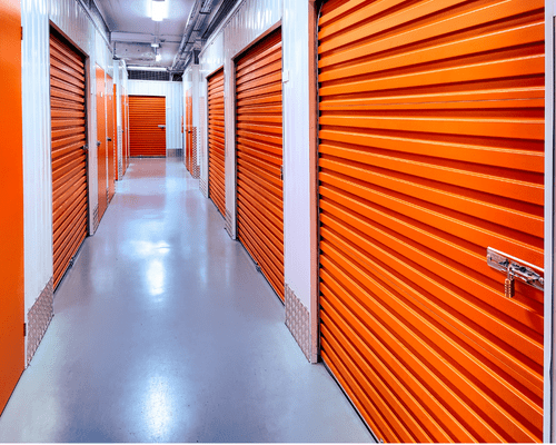 self storage facility painting A hallway in a self storage facility. The floor is shiny and gray and there are several orange overhead doors lining either side.