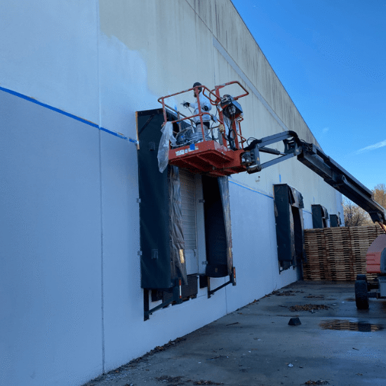 Commercial warehouse exterior painting with lift by DJ’s Painting in New Jersey